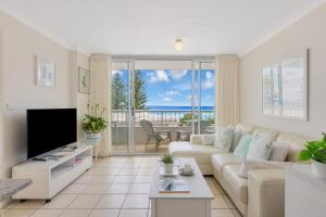 a living room with a couch and a tv at Eden Tower in Gold Coast