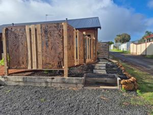 a row of wooden fences in front of a building at Pemberton Japanese Garden Studio 2025 Winner Travellers Award in Pemberton
