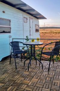 a patio with two chairs and a table and two chairs at Quentin Park Hideaway in Peterborough