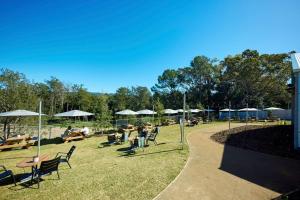 a park with chairs and tables and umbrellas at Coomera Lodge Hotel in Gold Coast