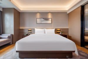 Giường trong phòng chung tại New Century Mansion Hotel Jiaxing Zhongyuan Nanhu Avenue