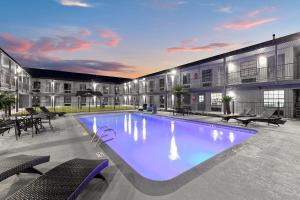 a large swimming pool in front of a building at Days Inn by Wyndham San Antonio Near Lackland AFB in San Antonio