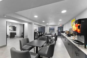 a restaurant with tables and chairs and a bar at Days Inn by Wyndham San Antonio Near Lackland AFB in San Antonio