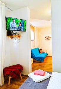 a living room with a flat screen tv on a wall at Comfortable Rooms - City Place in Split