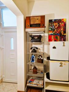 a refrigerator in a room with a shelf at Comfortable Rooms - City Place in Split