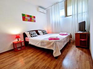 a bedroom with a bed and a television in it at Comfortable Rooms - City Place in Split