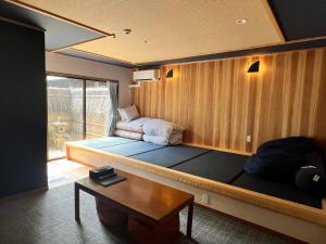 Letto o letti in una camera di Onsen & Garden -Asante Inn-