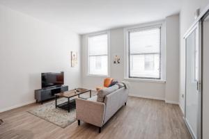 a living room with a couch and a table at CozySuites Sky Central #4 in Cincinnati