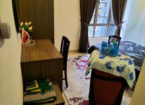 a bedroom with a desk and a bed and a table at 4H Guesthouse Cameron Highland in Brinchang