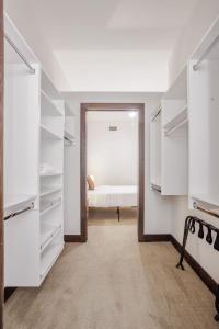 a bedroom with white closets and a bed in the background at CozySuites Sky Central #6 in Cincinnati