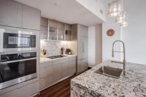 a kitchen with a sink and a stove top oven at CozySuites Sky Central #6 in Cincinnati