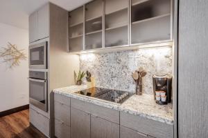 a kitchen with a sink and a counter top at CozySuites Sky Central #6 in Cincinnati