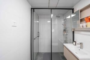 a bathroom with a glass shower and a sink at Yi Du Home with City View - Family Suite 500m to Nanjing West Rd Near People's Square -Credit Cards Accepted in Shanghai +78 photos