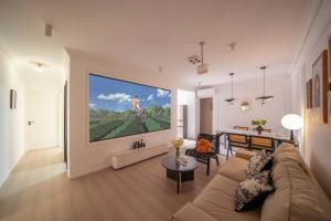 a living room with a large painting on the wall at Yi Du Home with City View - Family Suite 500m to Nanjing West Rd Near People's Square -Credit Cards Accepted in Shanghai