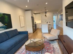 a living room with a blue couch and a table at Hoboken 3BR Queen Loft in Hoboken