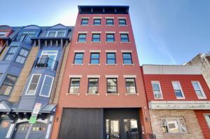 a row of colorful buildings on a city street at Hoboken 3BR Queen Loft in Hoboken