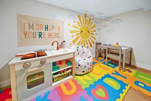 a playroom with a pretend kitchen and a table at Luxury Trails Escape in Boone