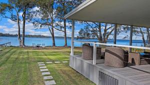 a porch of a house with a view of the water at Billyz Basin by Experience Jervis Bay in St Georges Basin