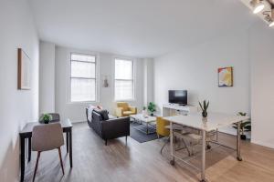 a living room with a table and a dining room at CozySuites Sky Central #7 in Cincinnati