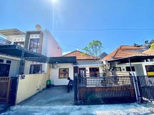a man is standing in front of a house at Djanuraga House 6 in Darmasaba