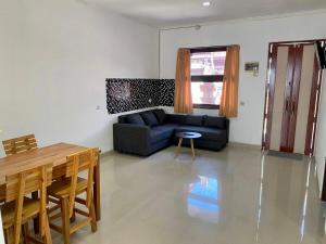 a living room with a couch and a table at Djanuraga House 6 in Darmasaba +5 photos