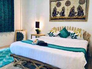 a bedroom with a bed with a stuffed animal on it at Spirit Mountain in Ban Nong Thale
