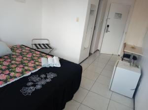 Ένα ή περισσότερα κρεβάτια σε δωμάτιο στο Silva Hospedagem FLAT BELLAGIO BEIRA MAR