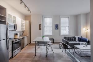 a kitchen and living room with a couch and a table at CozySuites Sky Central #10 in Cincinnati