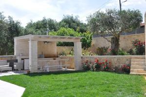 a pavilion in a garden with a table and chairs at Villa Eoli Corfu in Ágios Prokópios +62 photos