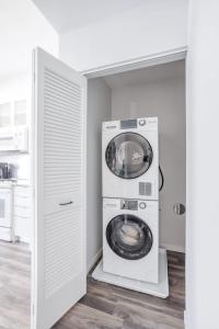 a washer and dryer in a kitchen with a door at CozySuites Sky Central #13 in Cincinnati +8 photos