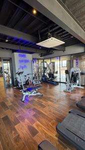a gym with several treadmills and exercise bikes at SIE7E NEW Condo in Tijuana