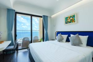 a bedroom with a bed with a view of the ocean at SenSea Hillside Apartment - Sunset Town in Phu Quoc +149 photos