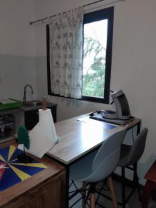 an office with a desk with a computer and a window at Loc' Avirons 10 bis in Les Avirons