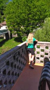 a woman walking over a stone bridge at Chez Alain in Fontenoy-le-Château