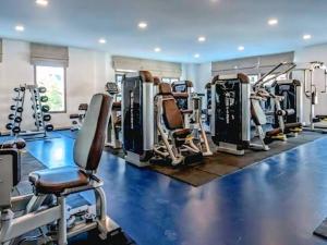 a gym with several treadmills and machines at Modern 1-Bedroom Condo with Pool View Arcadia Beach Continental Pattaya in Pattaya South