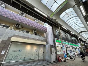 a large building with a building with bikes in it at 关西机场直达 i Home Osaka URBAN NOOK 舒适双床房 天下茶屋站步行3分钟 in Osaka