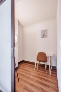 a dining room with a table and a chair at CozySuites Sky Central #21 in Cincinnati