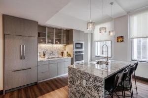 a kitchen with a large island with a counter top at CozySuites Sky Central #21 in Cincinnati