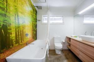 a bathroom with a large painting on the wall at Yarra Valley 2BR Lux Vineyard Retreat in Dixons Creek