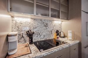 a kitchen with a sink and a counter top at CozySuites Sky Central #22 in Cincinnati +8 photos