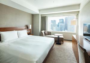 a hotel room with a large bed and a window at Odakyu Hotel Century Southern Tower in Tokyo +86 photos