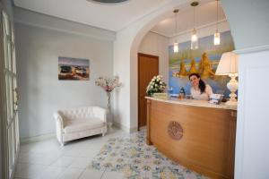 a woman sitting at a counter in a salon at Azienda Agrituristica Vivi Natura in Pompei
