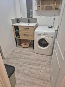 a small bathroom with a washing machine and a sink at Maison La Praline in Arnas +26 photos