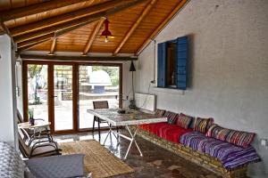 a living room with a couch and a table at The Ranch of Ancient Ilida in Amalias