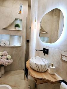 a bathroom with a round sink and a mirror at Frem lord in La Spezia +70 photos
