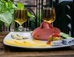 a plate of food and two glasses of wine at Crown Home in Cairo