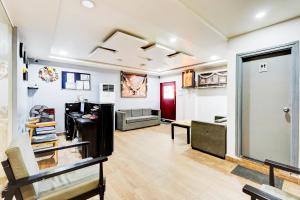a living room with a couch and a table at Super Townhouse Tirupati in Tirupati