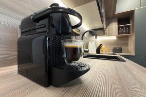 a black coffee maker sitting on a kitchen counter at Apartmán Klement in Znojmo +13 photos
