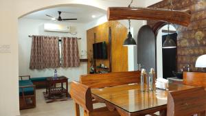 a dining room with a wooden table and chairs at Resort Morning Glory in Lataguri