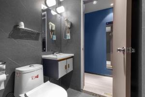 a bathroom with a white toilet and a sink at Jinjiang Inn Wenzhou Shuangyu The Terminal in Jiangjunqiao +144 photos